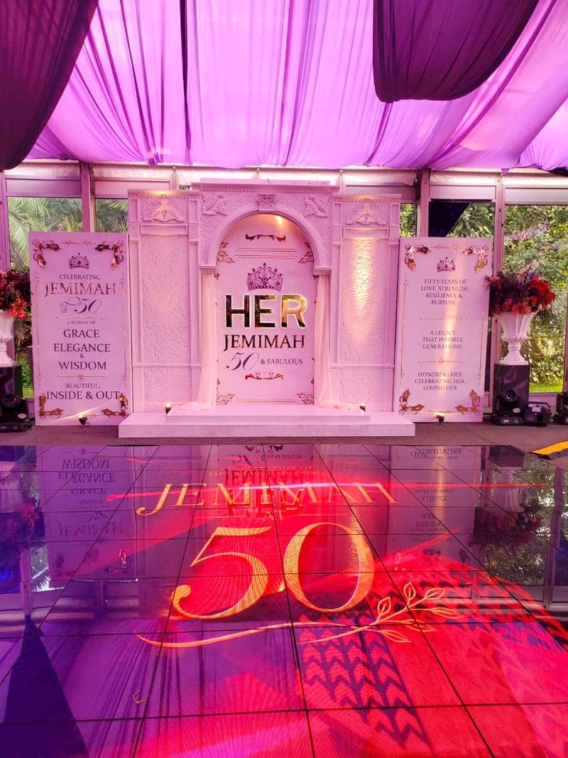 Cover of the Jemimah at 50 album: a white-and-gold 'HER — Jemimah 50 & Fabulous' backdrop with a mirrored dance floor projecting a gold 50