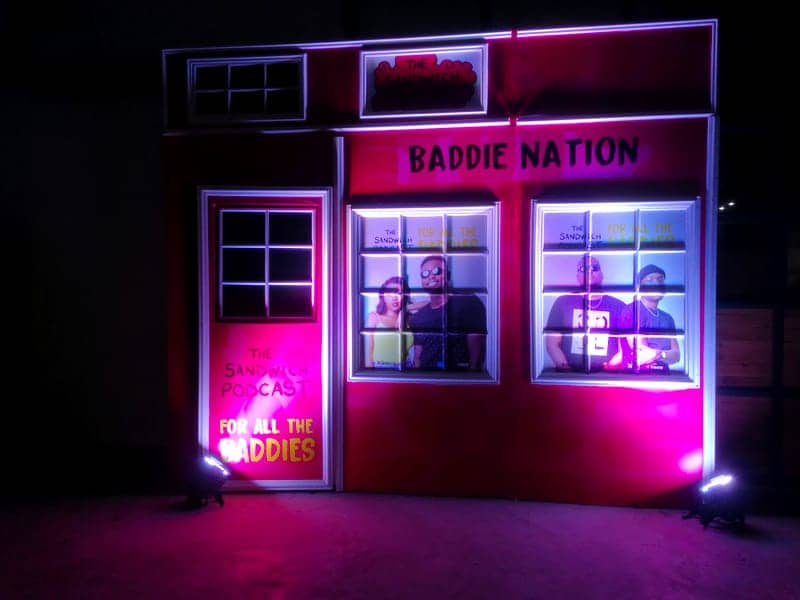Cover of The Sandwich Podcast album: a pink 'Baddie Nation' storefront facade set with lit windows and podcast branding