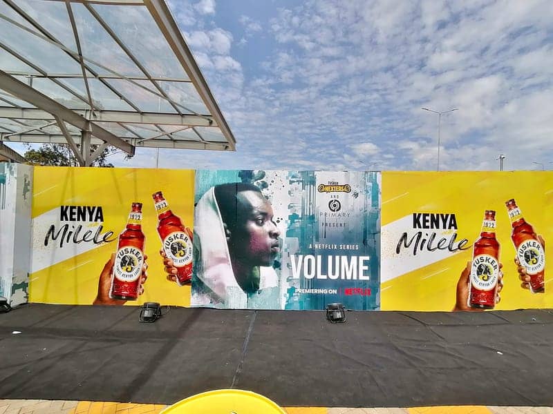 Cover of the Tusker x Volume album: a Tusker 'Kenya Milele' and Netflix 'Volume' billboard wall under a cloudy sky