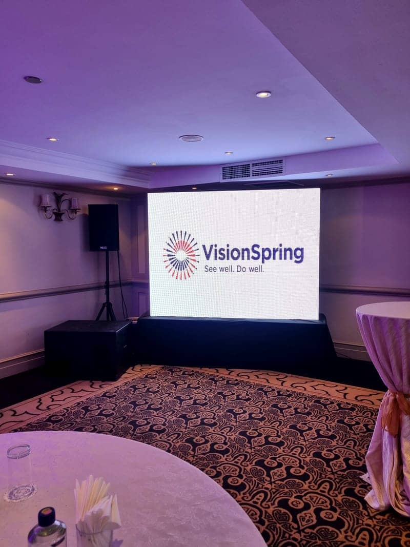Cover of the VisionSpring album: a VisionSpring See well Do well LED screen in a draped banquet hall